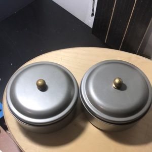 2 round metal containers